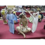 A Lladro 'Yawning Boy' and two Nao figures, including standing girl in a blue dress and a seated