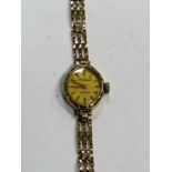 A 9ct Gold Cased Ladies Wristwatch, the oval dial with baton markers, to integral bracelet with