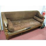 An Elm Framed Victorian Settee, padded arms with scrolled ends, baluster supports and tapering legs,