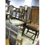 A Pair of Early XX Century Mahogany Rail Back Dining Chairs on spade feet, a similar carver