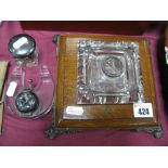 An Early XX Century Glass Inkwell, in oak stand, glass horseshoe inkwell and one other.