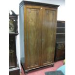 A 1920's Mahogany Double Wardrobe, with stepped pediment, twin doors, carved vase, ball and claw