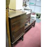 An Early XX Century Oak Music Cabinet, on barley twist and black supports, together with a piano