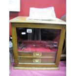 A Late XIX Century Oak Table Top Cabinet, with glazed door, campaign handles to twin interior