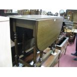 A 1920's Oak Gate Leg Table, with drop leaves, on turned and block supports.