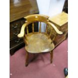 A Stained Wooden Windsor Smokers Style Chair, with spindle supports and twin stretchers to splayed