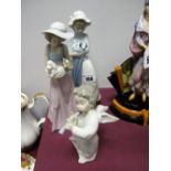 A Lladro Model of an Angel Playing a Horn, 16cm, and two Nao figures of young girls holding puppies.