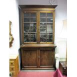 An Early XX Century Mahogany Bookcase, shaped cornice, twin glazed astragal doors, base, panelled