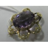 An Edwardian Single Stone Brooch, oval collet set to the centre, within pearl set border,