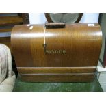 An Oak Domed Cased Singer Sewing Machine.