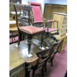 An Edwardian Walnut American Rocker, with spindle supports, upholstered in a red moquette together