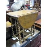 A 1920's Gate Leg Table, with an oval top, moulded edge, barley twist supports.