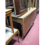 A XIX Century Mahogany Drop Leaf Dining Table, on turned supports.