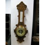 An Early XX Century Oak Aneroid Barometer, with top and bottom, temperature gauge, dial with brass