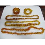 A Butterscotch Amber Bead Necklace, of polished shards, 34.5cm long, together with two others with