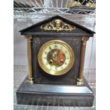 A XIX Century Black Slate Mantel Clock, with twin brass columns, circular dial, on stepped plinth