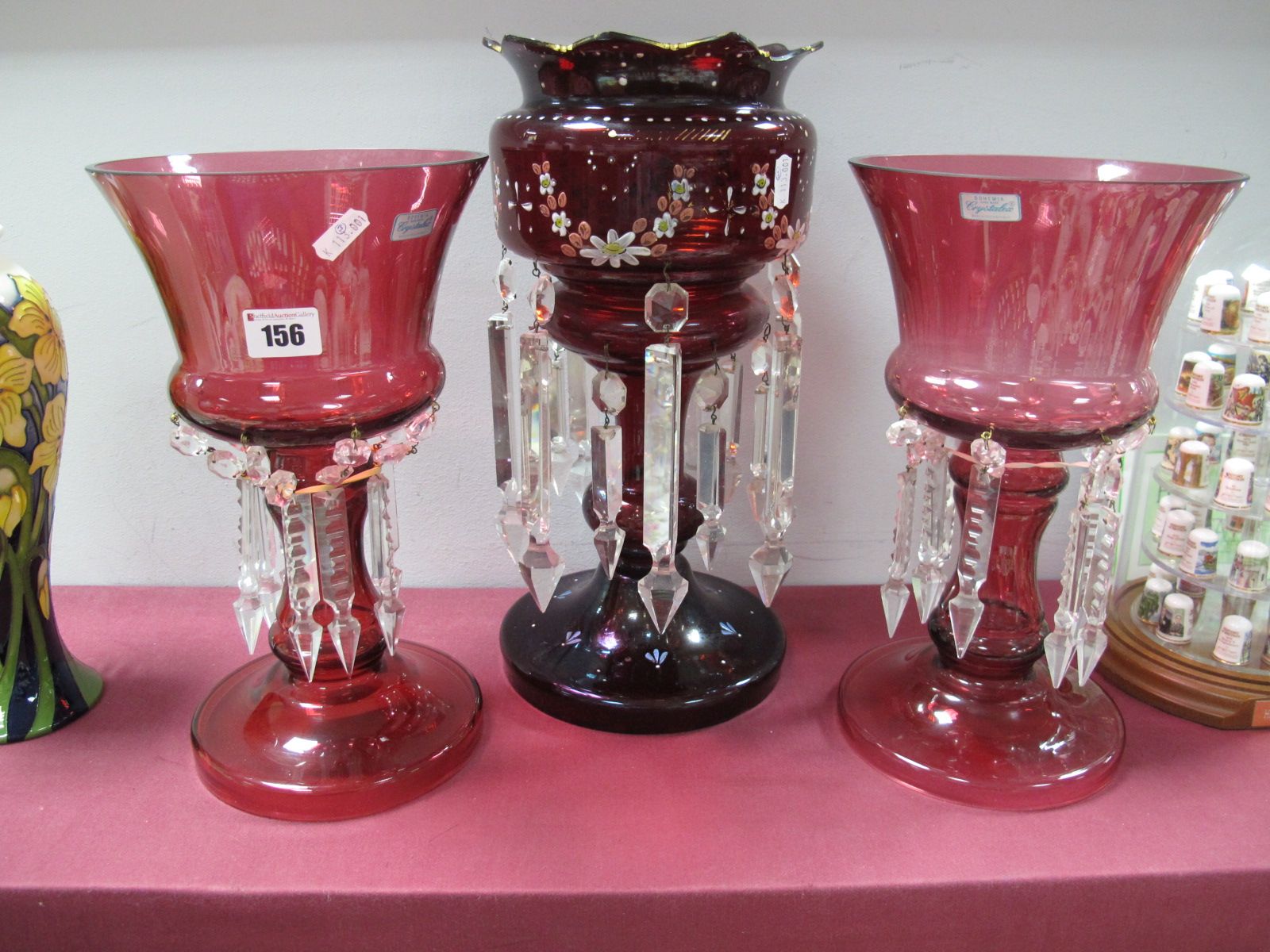 A Pair of Bohemia Crystalex Cranberry Lustres, with faceted drops, 30cm high; a XIX Century single