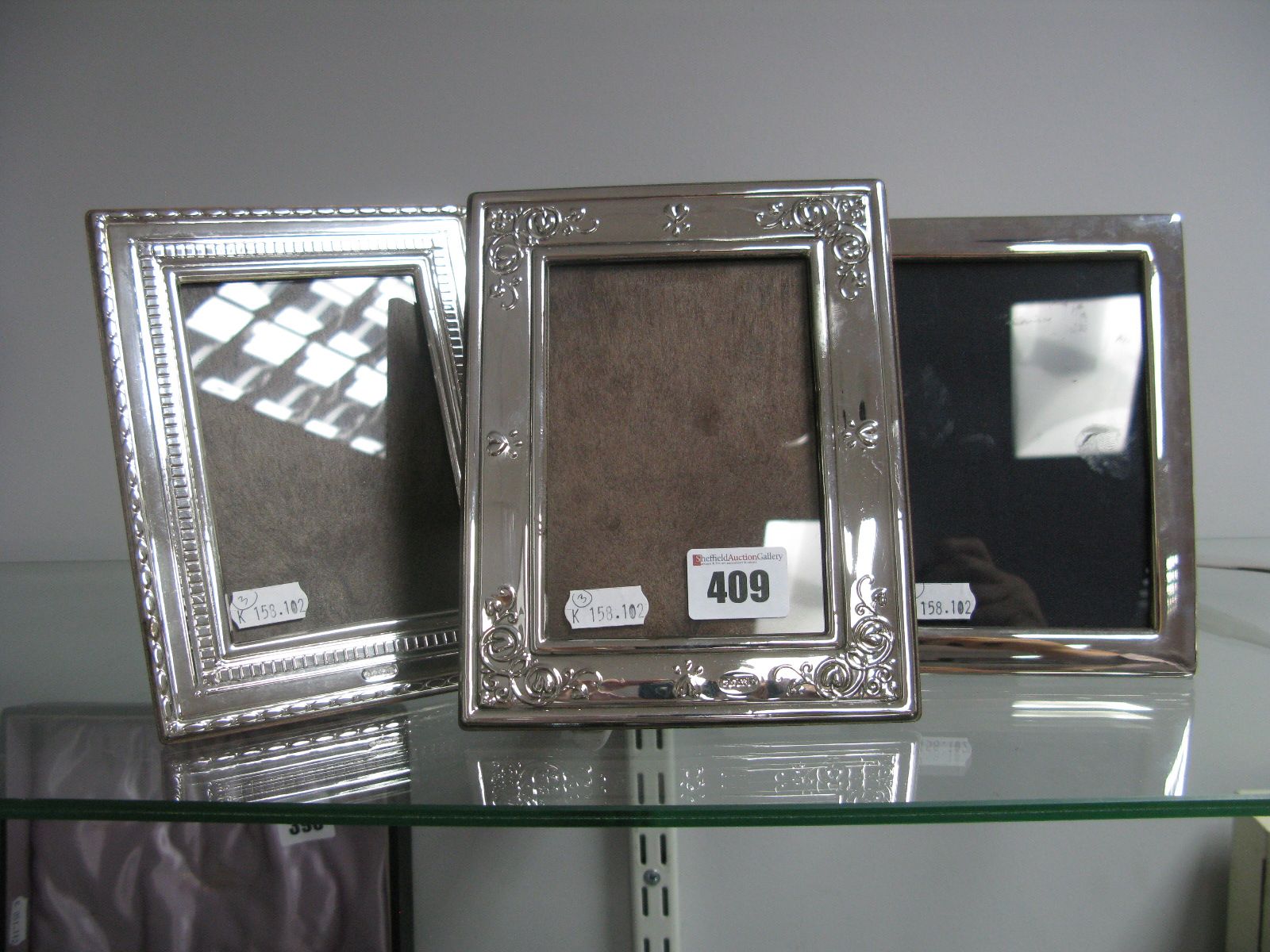 Two Hallmarked Silver Mounted Photograph Frames, each on brown plastic easel back, overall height