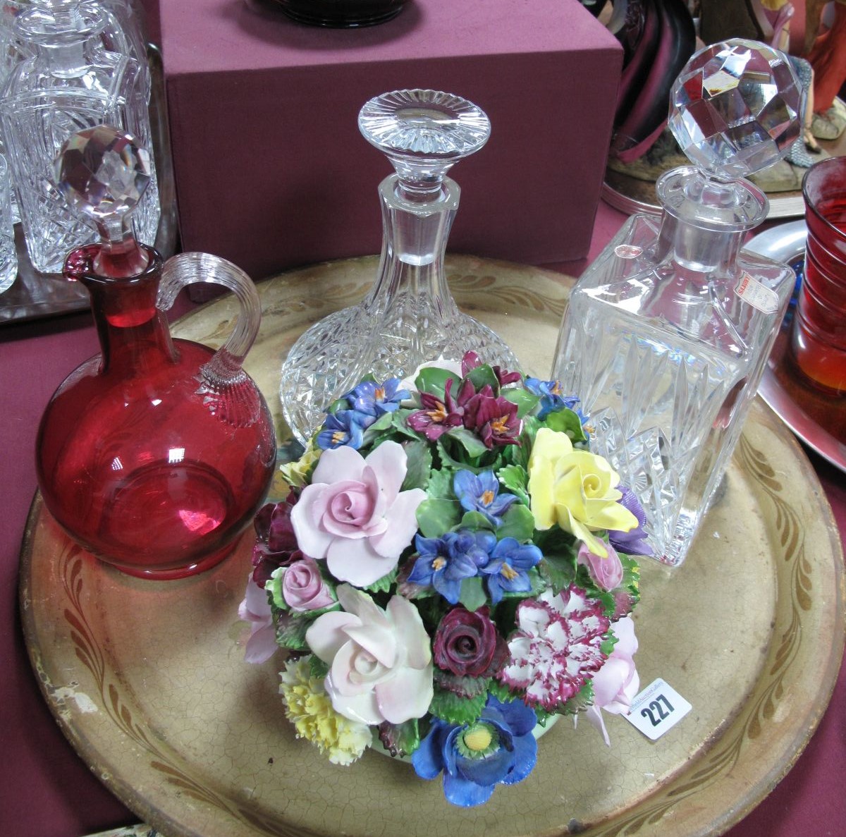 A Cranberry Glass Jug, of globular form, tall neck, clear glass applied handle and stopper, a