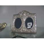 A Modern Hallmarked Silver Mounted Photograph Frame, double aperture, detailed with cherubs, on blue