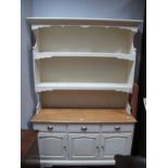 A Painted Dresser, with stepped pediment, two shelves and shaped sides, the base with a polished