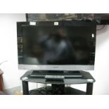 A Sony Bravia 26" TV, with remote and stand.