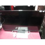 A Sony 32" LCD Flatscreen TV, with remote control.