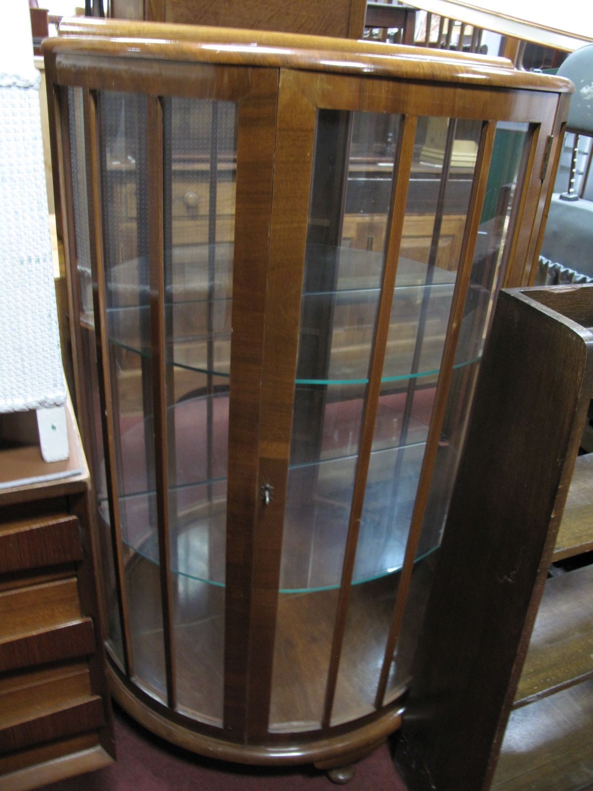 A Mid XX Century Walnut Demi Lune China Cabinet, with interior shelving.