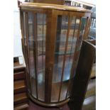 A Mid XX Century Walnut Demi Lune China Cabinet, with interior shelving.