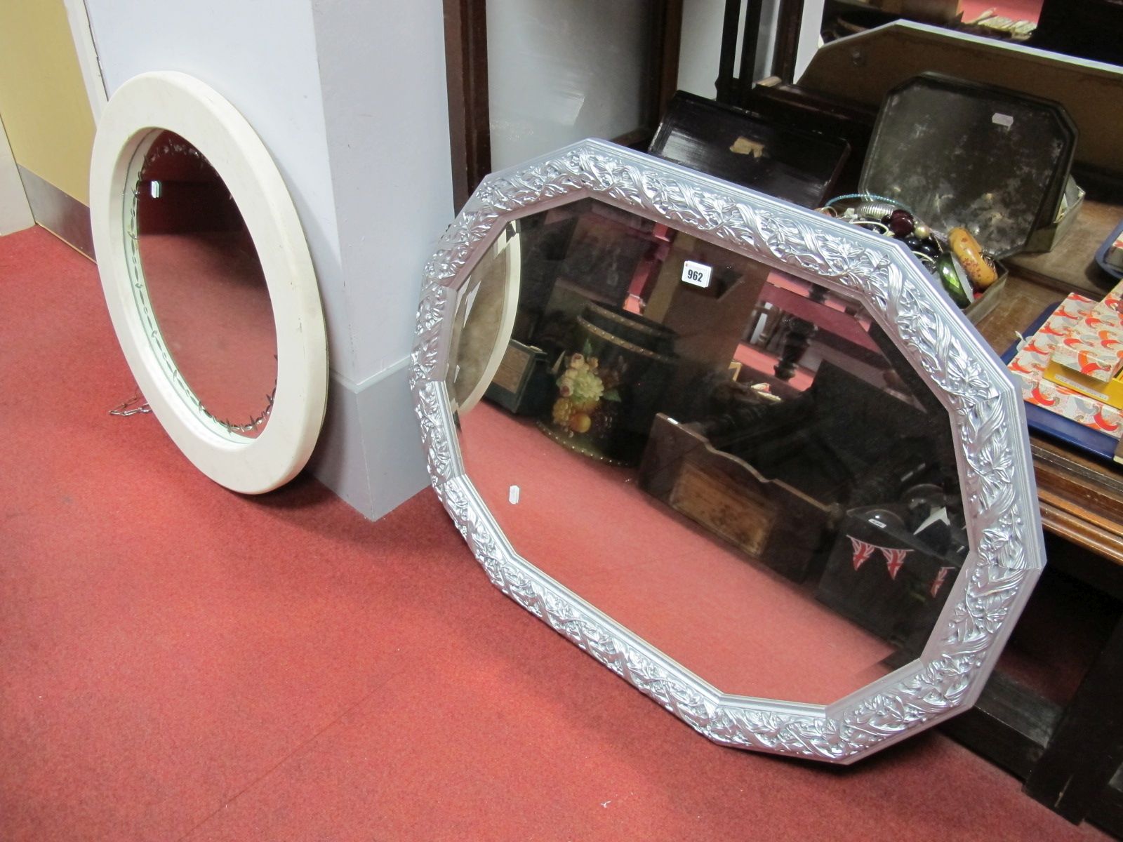 A Circular Wall Mirror, in cream frame, twelve sided bevelled mirror in silvered frame. (2)