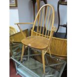 An Ercol Open Armchair, spindle arched back, shaped open arms on 'H' stretchered legs.