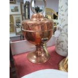 A XIX Century Copper Tea Urn, with ebonised finial and turned handles, brass tap, on circular