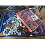 A Collection of Assorted Bead Necklaces; together with a 'Stackers' pink jewellery tray and a purple