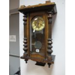 A XIX Century Walnut Viennese Wall Clock, with black Roman numerals to cream chapter ring.