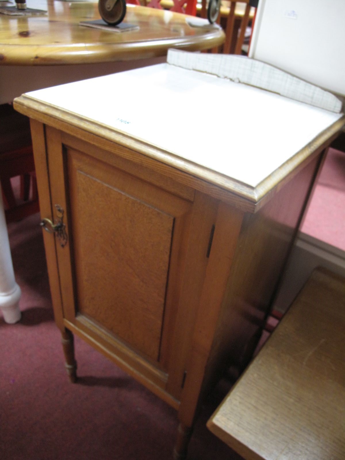 An Early XX Century Light Oak Pot Cupboard, with low back on turned legs.