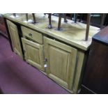 A Continental Oak Sideboard, with central drawer and three cupboard doors, 172cm wide.