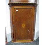 A George III Oak Hanging Corner Cupboard, dentil cornice, canted ends with central door inlaid