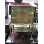 A Mid XX Century Walnut Serpentine Shaped Chest of Drawers, with a quarter veneered top, hinged