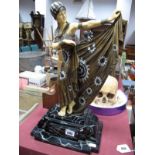 A Reproduction Resin Art Deco Style Standing Figurine in Period Dress, mounted on a marbled effect