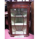 A Mahogany Corner Wall Cabinet, with dentil cornice and astragal glazed door.