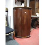 A Late XVIII Century Mahogany Bow Fronted Corner Cupboard, with a moulded pediment, three internal