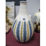 An Early 1950's Poole Pottery White Earthenware Carafe Vase, the blue and yellow stylised leaf