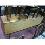 A 1960's Teak Sideboard, with a low back, three small drawers, three cupboard doors, on square legs.