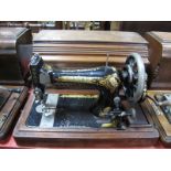 An Early XX Century Singer Sewing Machine, in walnut case.