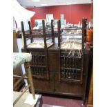 A Mid XX Century Mahogany Effect Sideboard, fall front concealing a bank of three pull trays, sewing