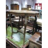An Edwardian Inlaid Rosewood Window Table, with wavy octagonal top and undershelf, united by sabre