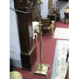 An Early XX Century Brass Standard Lamp, with Corinthian column, on stepped square pedestal and four