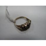 A 9ct Gold Ring, graduated set within scroll carved style setting.