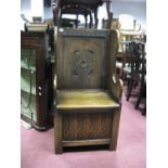 An Oak Hall Chair, top rail with knulled decoration, shaped back panel with lozenge decoration,