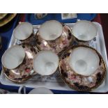 Six Royal Crown Derby 3788 Pattern Cups and Saucers, with gilt and floral sprays and blue rims.